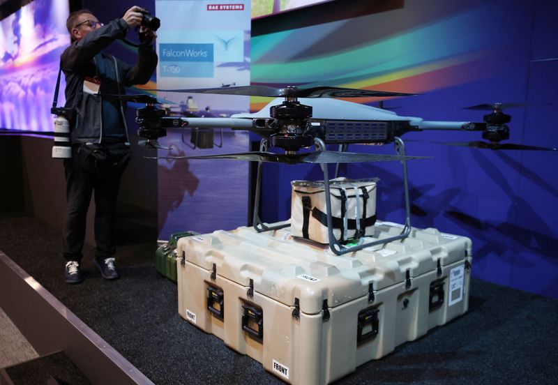 &copy; Reuters. A photographer takes pictures of a Falcon Works T-150 drone on display in a room at the BAE Systems Warton factory in Warton, Britain, July 15, 2025. REUTERS/Phil Noble