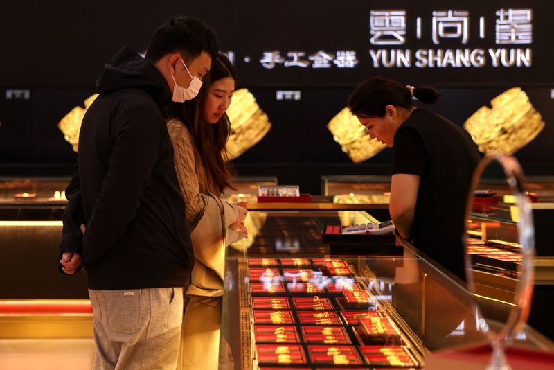 Gold slide continues, stocks keep calm