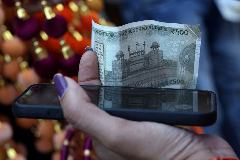 Rupee cracks below 90 to the dollar, hit by tariffs, capital outflows