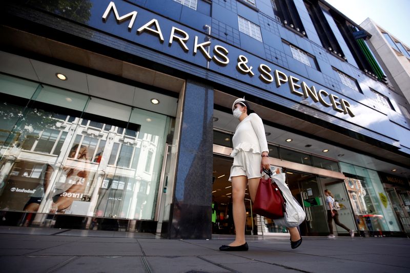 &copy; Reuters. FILE PHOTO: A woman walks past a Marks & Spencer store at Oxford Street, amid the outbreak of the coronavirus disease (COVID-19), in London, Britain, July 20, 2020. REUTERS/Henry Nicholls/File Photo  
