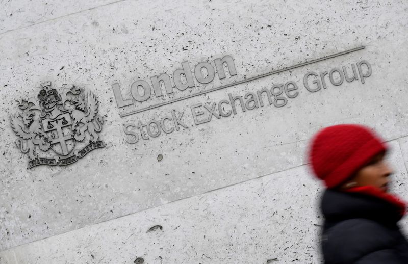 &copy; Reuters. FILE PHOTO: A woman walks past the London Stock Exchange building in the City of London, Britain, January 16 , 2017. REUTERS/Toby Melville
