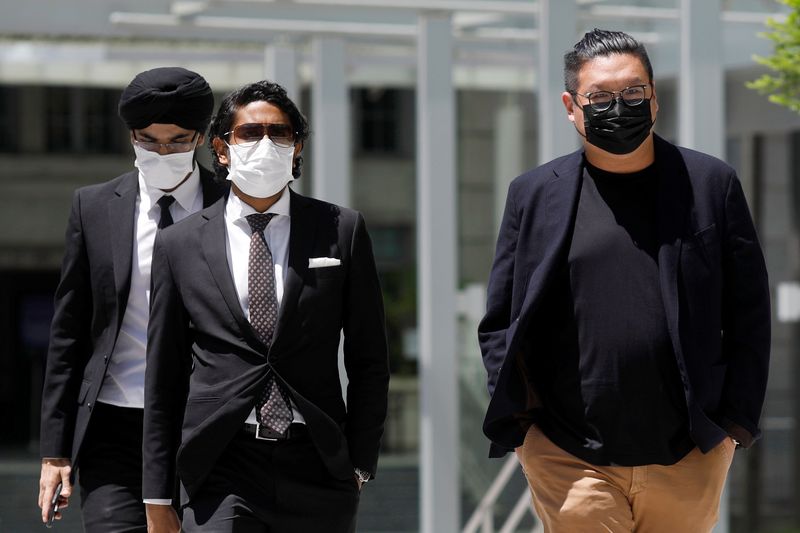 &copy; Reuters. FILE PHOTO: Ng Yu Zhi (R), a director of Envy Global Trading, arrives at the State Court in Singapore  April 20, 2021.  REUTERS/Edgar Su