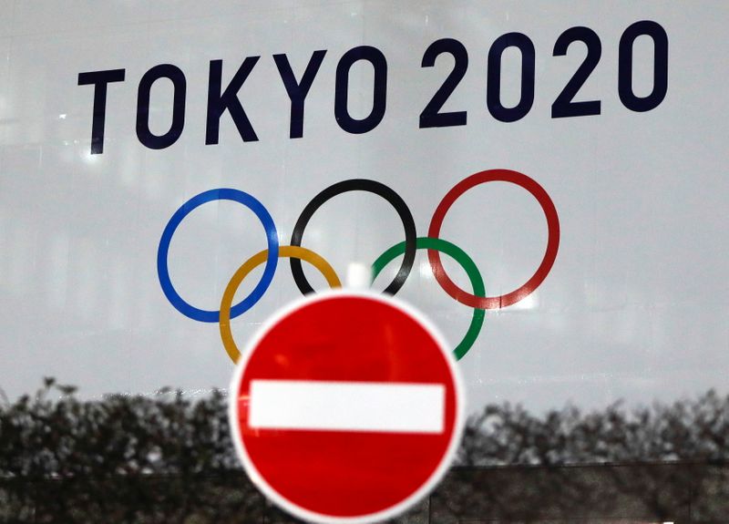 &copy; Reuters. The logo of Tokyo 2020 Olympic Games that have been postponed to 2021 due to the coronavirus disease (COVID-19) outbreak, is seen through a traffic sign at Tokyo Metropolitan Government Office building in Tokyo, Japan January 22, 2021. REUTERS/Issei Kato