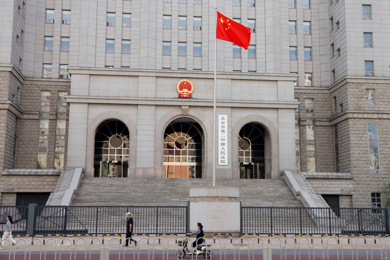 &copy; Reuters. FILE PHOTO: People walk past one of the entrances of Beijing No. 2 Intermediate People's Court where Australian writer Yang Hengjun is expected to face trial on espionage charges, in Beijing, China May 27, 2021. REUTERS/Carlos Garcia Rawlins/File Photo