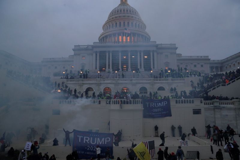 &copy; Reuters. FILE PHOTO: Police officers stand guard as supporters of U.S. President Donald Trump gather in front of the U.S. Capitol Building in Washington, U.S., January 6, 2021. REUTERS/Leah Millis