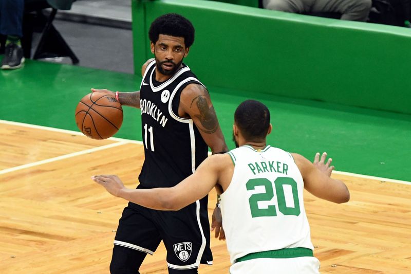 &copy; Reuters. May 30, 2021; Boston, Massachusetts, USA; Brooklyn Nets guard Kyrie Irving (11) dribbles the ball in front of Boston Celtics forward Jabari Parker (20) during the second half of game four in the first round of the 2021 NBA Playoffs. at TD Garden. Mandator
