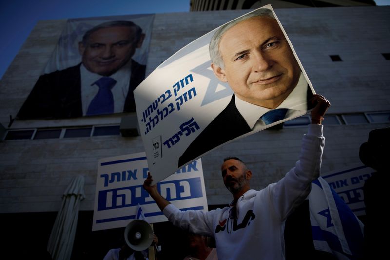 &copy; Reuters. FILE PHOTO: Supporters of Israeli Prime Minister Benjamin Netanyahu protest outside Likud Party headquarters in Tel Aviv, Israel November 22, 2019. The placards in Hebrew read, "Strong in security, strong in Economy ".  REUTERS/Corinna Kern/File Photo