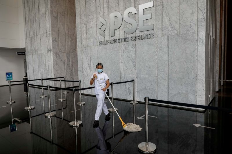 &copy; Reuters. FILE PHOTO: A janitor wearing a face mask cleans the lobby of the Philippine Stock Exchange amid the coronavirus disease (COVID-19) outbreak, in Taguig City, Metro Manila, Philippines, Sept. 30, 2020. REUTERS/Eloisa Lopez