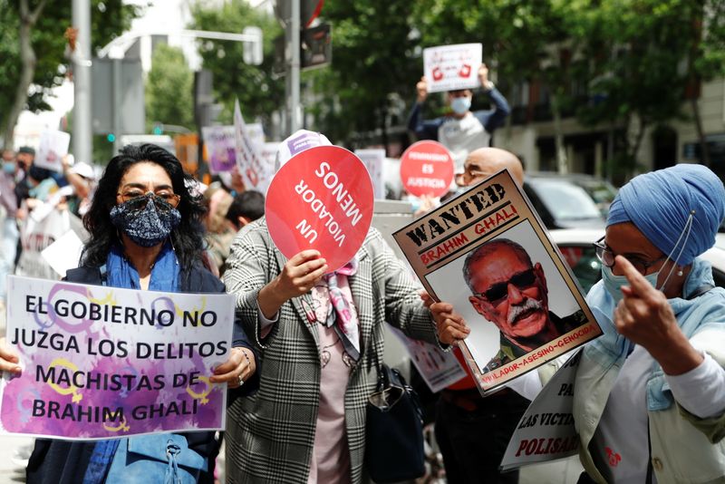 &copy; Reuters. People hold placards as they protest against Brahim Ghali, president of the Sahrawi Arab Democratic Republic (SADR) and Secretary General of the Polisario Front (Popular Front for the Liberation of Saguia el-Hamra and Rio de Oro), outside Spanish High Cou
