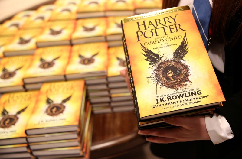 &copy; Reuters. FILE PHOTO: A store assistant holds copies of the book of the play of Harry Potter and the Cursed Child parts One and Two at a bookstore in London, Britain July 31, 2016. REUTERS/Neil Hall