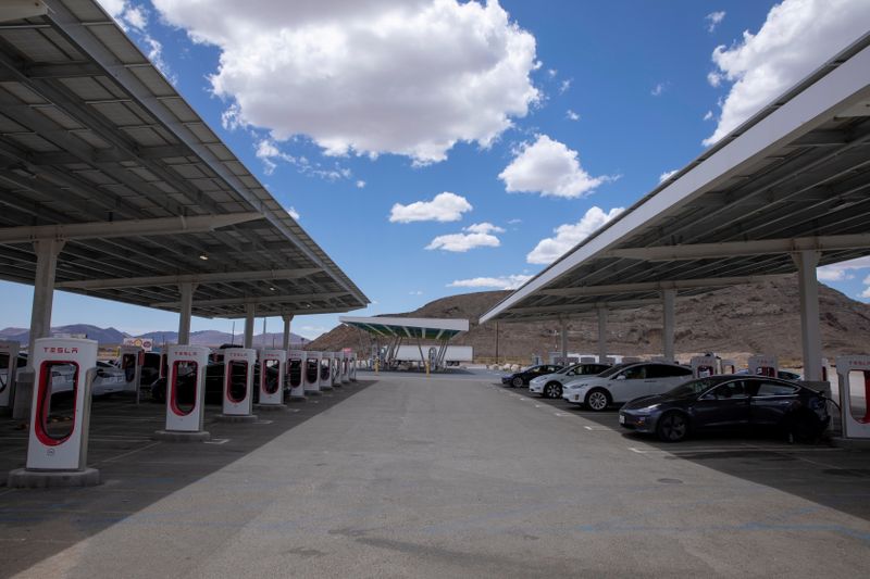 © Reuters. FILE PHOTO: Tesla electric vehicles recharge at a large supercharging station located between Los Angeles and Las Vegas in Baker, California, U.S., May 21, 2021. REUTERS/Mike Blake/File Photo