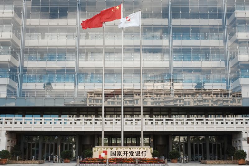 &copy; Reuters. A Chinese flag (C) flutters at the headquarters of China Development Bank (CDB) in Beijing, China September 23, 2018. Picture taken September 23, 2018.  REUTERS/Florence Lo/Files