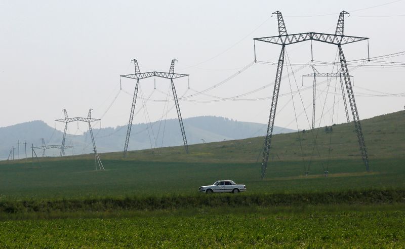 &copy; Reuters. A car drives along a regional highway near electricity pylons, located in agrarian fields, in the Republic of Khakassia, Russia July 12, 2018. Picture taken July 12, 2018. REUTERS/Ilya Naymushin
