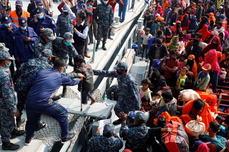 &copy; Reuters. FILE PHOTO: Bangladesh Navy personnel help a disabled Rohingya refugee child to get off from a navy vessel as they arrive at the Bhasan Char island in Noakhali district, Bangladesh, December 29, 2020. REUTERS/Mohammad Ponir Hossain//File Photo
