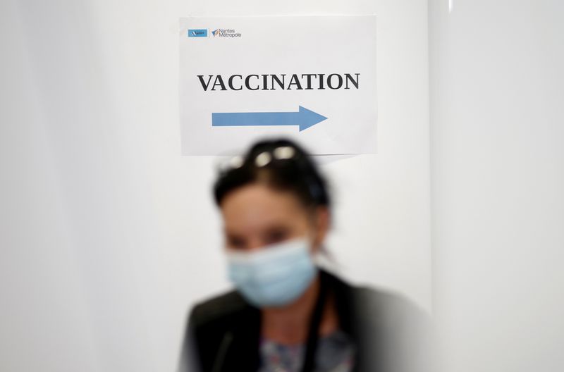 &copy; Reuters. FILE PHOTO: A woman walks past a sign reading "Vaccination" in a vaccination center in Nantes as part of the coronavirus disease (COVID-19) vaccination campaign in France, June 3, 2021. REUTERS/Stephane Mahe/File Photo