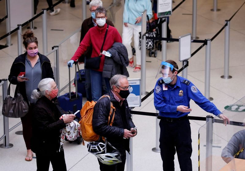 &copy; Reuters. FILE PHOTO: A TSA worker directs travelers to the next station at a security checkpoint at Seattle-Tacoma International Airport in SeaTac, Washington, U.S. April 12, 2021.  REUTERS/Lindsey Wasson