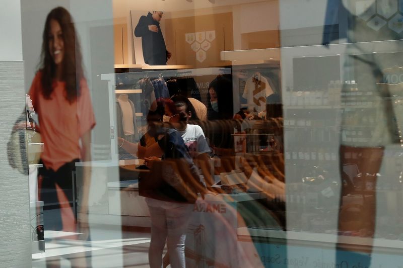 &copy; Reuters. FILE PHOTO: People are seen reflected in a storefront window shopping at Roosevelt Field shopping mall in Garden City, New York, U.S., May 20, 2021. REUTERS/Shannon Stapleton