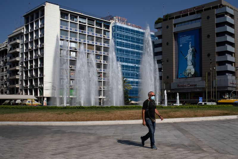 &copy; Reuters. FILE PHOTO: A man wearing a protective face mask makes his way on Omonia square in Athens, Greece, September 3, 2020. REUTERS/Alkis Konstantinidis