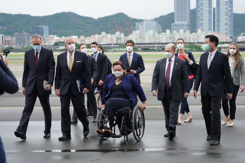 &copy; Reuters. Taiwan Foreign Minister Joseph Wu and Brent Christensen, director of the American Institute in Taiwan, walk with U.S. Senators Tammy Duckworth (D-IL), Dan Sullivan (R-AK) and Chris Coons (D-DE) after their arrival via a U.S. Air Force freighter at Taipei 