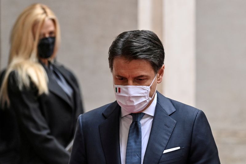&copy; Reuters. FILE PHOTO: Italy's outgoing Prime Minister, Giuseppe Conte walks past his companion Olivia Paladino as he leaves following a formal handover ceremony with incoming Prime Minister Mario Draghi at Palazzo Chigi in Rome, Italy February 13, 2021. Alberto Piz