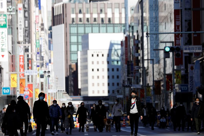 &copy; Reuters. FILE PHOTO: Pedestrians wearing protective masks, amid the coronavirus disease (COVID-19) outbreak, make their way at Ginza shopping district which closed to cars on Sunday in Tokyo, Japan, January 10, 2021. REUTERS/Kim Kyung-Hoon