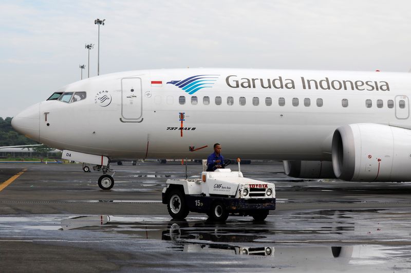 &copy; Reuters. FILE PHOTO: A technician rides a car as he passes Garuda Indonesia's Boeing 737 Max 8 airplane parked at the Garuda Maintenance Facility AeroAsia, at Soekarno-Hatta International airport near Jakarta, Indonesia, March 13, 2019.REUTERS/Willy Kurniawan