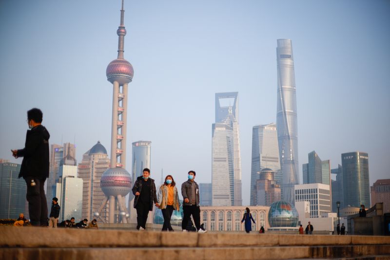 &copy; Reuters. People walk at the Bund, in front of Lujiazui financial district of Pudong, on the day of the opening session of the Chinese People's Political Consultative Conference (CPPCC), in Shanghai, China March 4, 2021. REUTERS/Aly Song