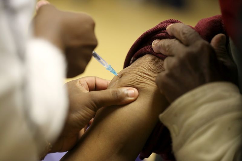 &copy; Reuters. A person receives a dose of a coronavirus disease (COVID-19) vaccine, as South Africa rolls out the coronavirus disease (COVID-19) vaccination to the elderly at the Munsieville Care for the Aged Centre outside Johannesburg, South Africa May 17, 2021. REUT