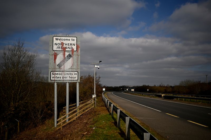 © Reuters. A defaced 'Welcome to Northern Ireland' sign is seen on the Ireland and Northern Ireland border reminding motorists that the speed limits will change from kilometres per hour to miles per hour on the border in Carrickcarnan, Ireland, March 6, 2021. Picture taken March 6, 2021. REUTERS/Clodagh Kilcoyne
