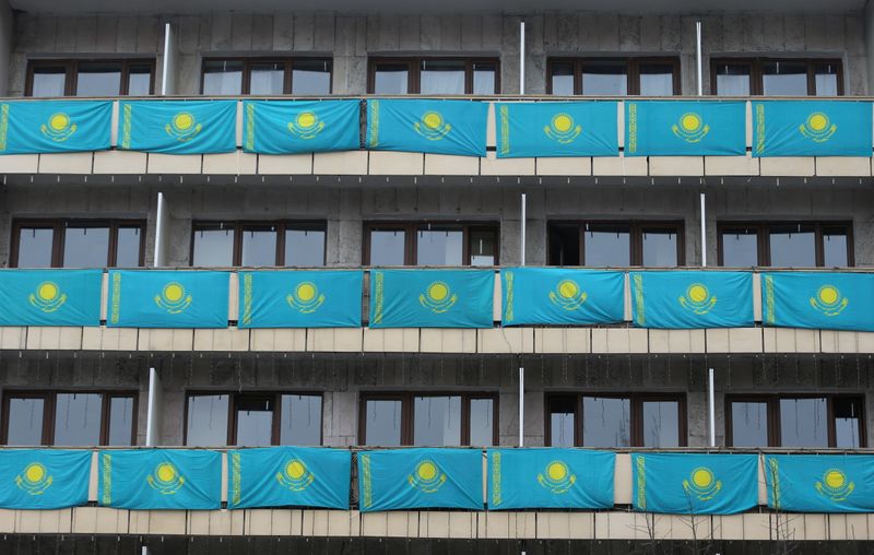 &copy; Reuters. Kazakh state flags hang out from balconies of a building on Independence Day in Almaty, Kazakhstan December 16, 2020. REUTERS/Pavel Mikheyev