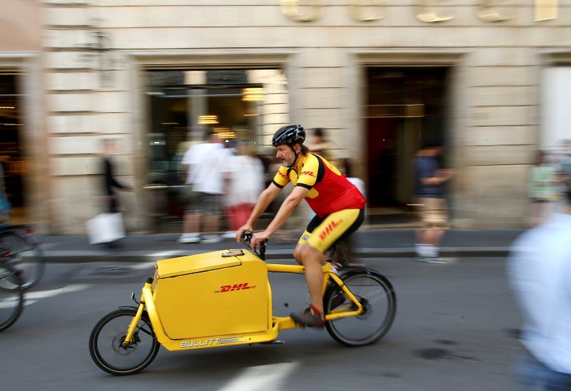 &copy; Reuters. FILE PHOTO: A DHL bike messenger rides in central Rome, Italy, June 6, 2018. REUTERS/Alessandro Bianchi/File Photo