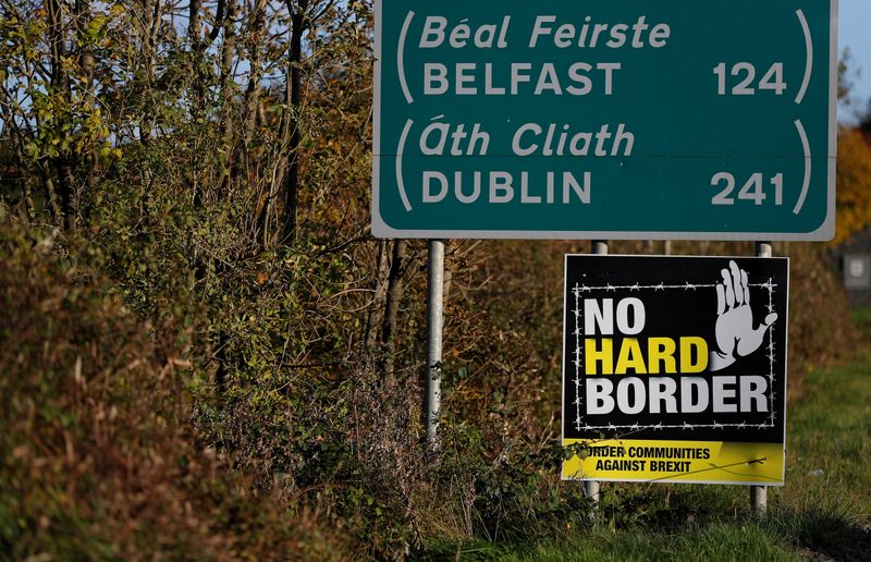 &copy; Reuters. FILE PHOTO: A 'No hard Border' poster is seen below a road sign on the Irish side of the border between Ireland and Northern Ireland near Bridgend, Ireland October 16, 2019. Picture taken October 16, 2019. REUTERS/Phil Noble
