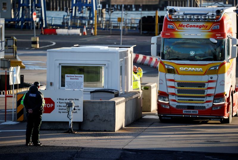 &copy; Reuters. FILE PHOTO: Police officers stand by port security as a lorry drives in at the entrance to the Port of Larne, Northern Ireland, Britain January 1, 2021. REUTERS/Phil Noble/File Photo