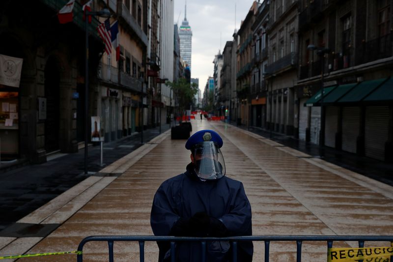 &copy; Reuters. FILE PHOTO: A police officer guards a closed road at the city center after amenities and businesses were shut for the second time this weekend due to overcrowding over the last few days, as the coronavirus disease (COVID-19) outbreak continues, in Mexico 