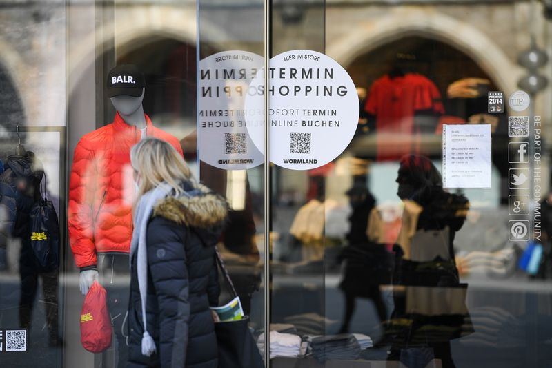 &copy; Reuters. FILE PHOTO: A woman passes a shop with a sticker reading "shopping by appointment" in the city center after the re-opening of certain businesses, as lockdown measures introduced due to the spread of the coronavirus disease (COVID-19) were eased, in Munich