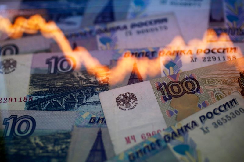 &copy; Reuters. A reflection of a yearly chart of U.S. dollars and Russian roubles are seen on rouble notes in this photo illustration taken in Warsaw November 7, 2014. The rouble recovered on Friday, paring heavy losses as investors anticipated possible action by the ce