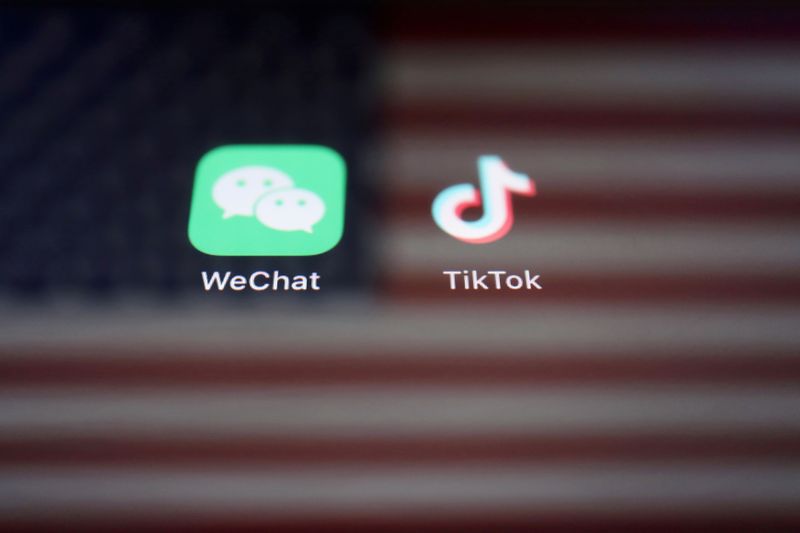 &copy; Reuters. FILE PHOTO: A reflection of the U.S. flag is seen on the signs of the WeChat and TikTok apps in this illustration picture taken September 19, 2020. REUTERS/Florence Lo/Illustration/File Photo