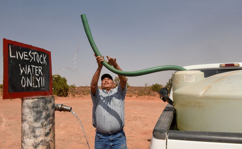 &copy; Reuters. FILE PHOTO: Eugene Boonie, 55, who is from Navajo Nation, fills up his water tank at the livestock water spigot in the Bodaway Chapter in the Navajo Nation, in Gap, Arizona, U.S. September 17, 2020. . REUTERS/Stephanie Keith