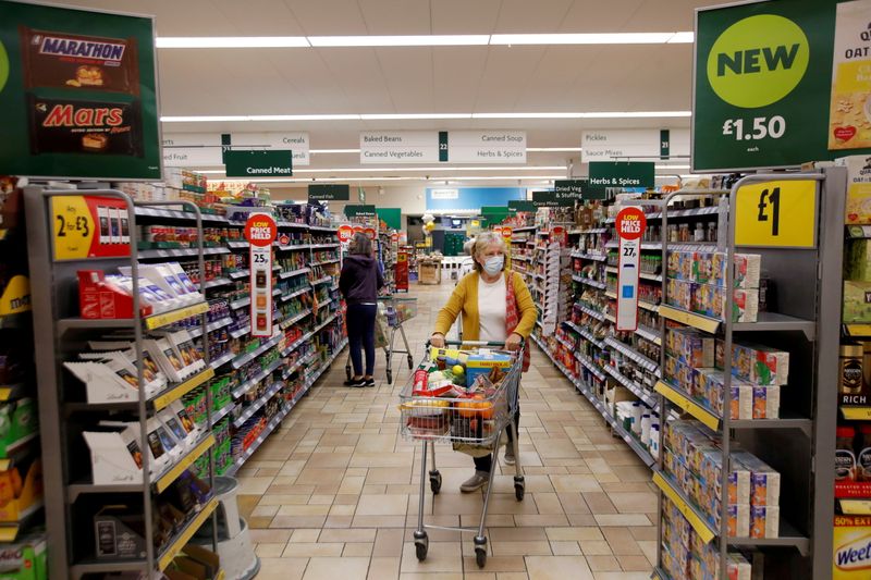 &copy; Reuters. FILE PHOTO: A customer wearing a protective face mask shops at a Morrisons store in St Albans, Britain, September 10, 2020.  REUTERS/Peter Cziborra/File Photo