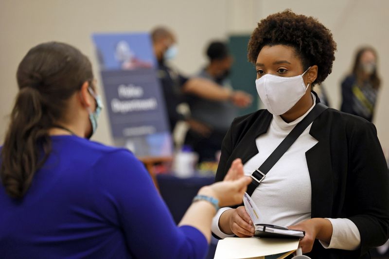 &copy; Reuters. FILE PHOTO: Britni Mann speaks with a potential employer during a job fair at Hembree Park in Roswell, Georgia, U.S. May 13, 2021.   REUTERS/Chris Aluka Berry