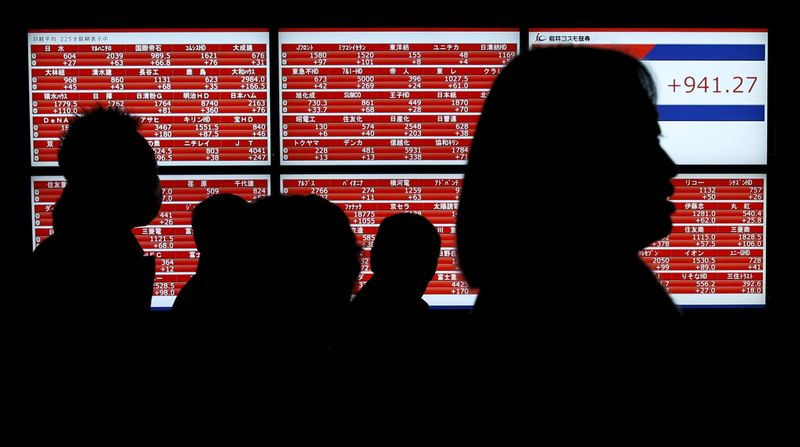 &copy; Reuters. Pedestrians walk past an electronic stock quotation board outside a brokerage in Tokyo, Japan January 22, 2016. Japan's Nikkei share average scored its biggest single-day gain in 4-1/2 months on Friday, helped by a weaker yen, a bounce in oil prices and a