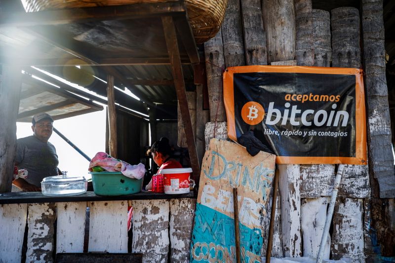 &copy; Reuters. FILE PHOTO: A banner that reads "We accept Bitcoin, free, fast and without contagion" is seen at a beach cafe on Punta Roca Beach in La Libertad, El Salvador April 25, 2021. REUTERS/Jose Cabezas/File Photo