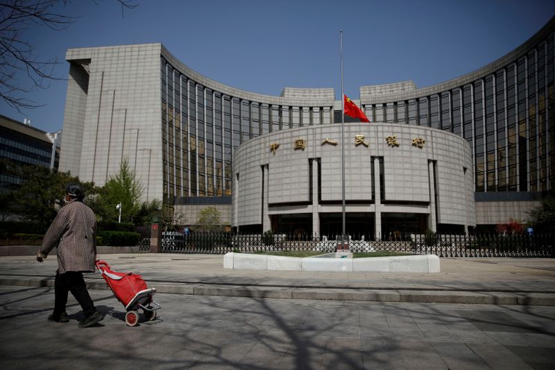 &copy; Reuters. FILE PHOTO: The Chinese national flag flies at half-mast at the headquarters of the People's Bank of China, the central bank (PBOC), as China holds a national mourning for those who died of the coronavirus disease (COVID-19), on the Qingming tomb-sweeping