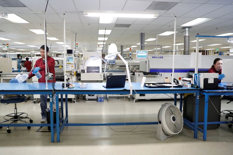 &copy; Reuters. FILE PHOTO: Workers disinfect a production line while maintaining social distancing at the start of a shift at Green Circuits as the company, an essential business, adapts to operating during the outbreak of the fast-spreading coronavirus disease (COVID-1