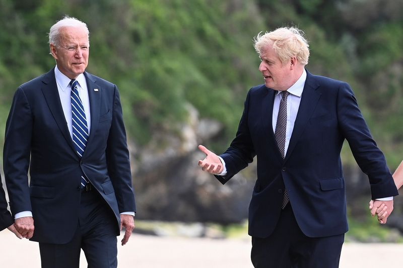 &copy; Reuters. Britain's Prime Minister Boris Johnson speaks with U.S. President Joe Biden while they walk with their wife Carrie Johnson (not seen) and U.S. first lady Jill Biden (not seen), outside Carbis Bay Hotel, Carbis Bay, Cornwall, Britain June 10, 2021. REUTERS