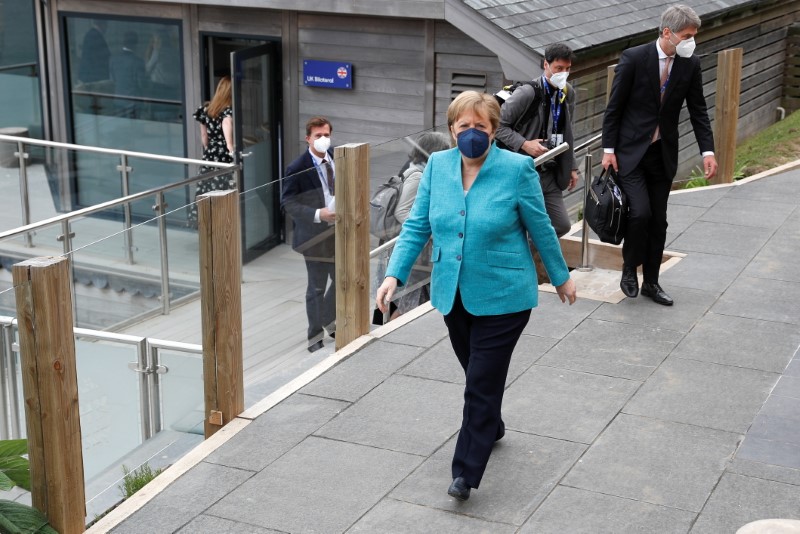 &copy; Reuters. German Chancellor Angela Merkel walks after a bilateral meeting with Britain's Prime Minister Boris Johnson during the G7 summit in Carbis Bay, Cornwall, Britain, June 12, 2021. REUTERS/Peter Nicholls/Pool