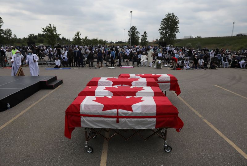 &copy; Reuters. Flag-wrapped coffins are seen outside the Islamic Centre of Southwest Ontario, during a funeral of the Afzaal family that was killed in what police describe as a hate-motivated attack, in London, Ontario, Canada June 12, 2021. REUTERS/Carlos Osorio