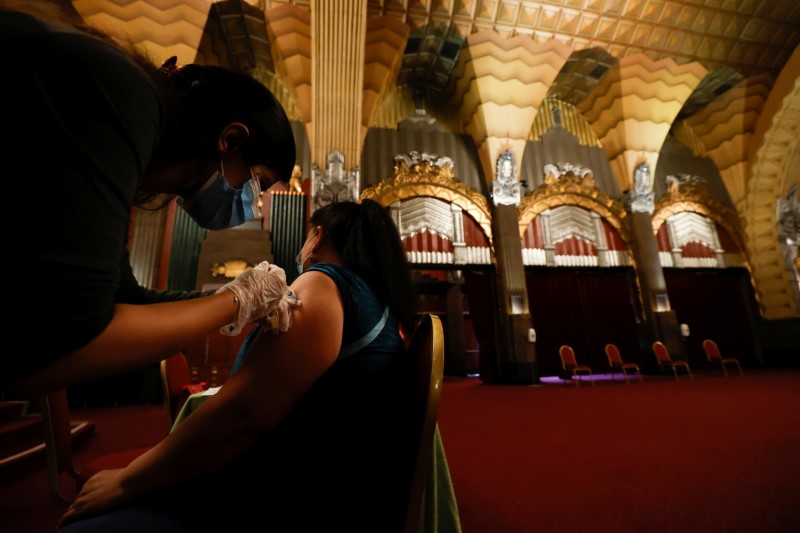 &copy; Reuters. A person receives a shot of the Pfizer-BioNTech coronavirus disease (COVID-19) vaccine with a chance to win a pair of tickets to see "Hamilton" at a pop-up vaccination clinic at Pantages theatre in Los Angeles, California, U.S., June 12, 2021.  REUTERS/Ma