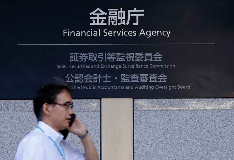 &copy; Reuters. FILE PHOTO: A man walks past a sign of Japan's Financial Services Agency in Tokyo August 7, 2014.  REUTERS/Toru Hanai