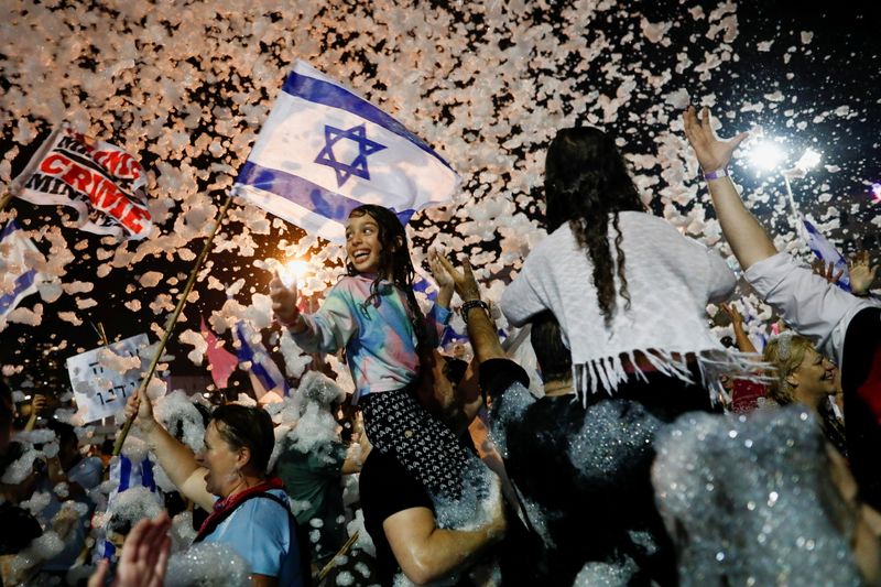 &copy; Reuters. People celebrate after Israel's parliament voted in a new coalition government, ending Benjamin Netanyahu's 12-year hold on power, at Rabin Square in Tel Aviv, Israel June 13, 2021. REUTERS/Corinna Kern